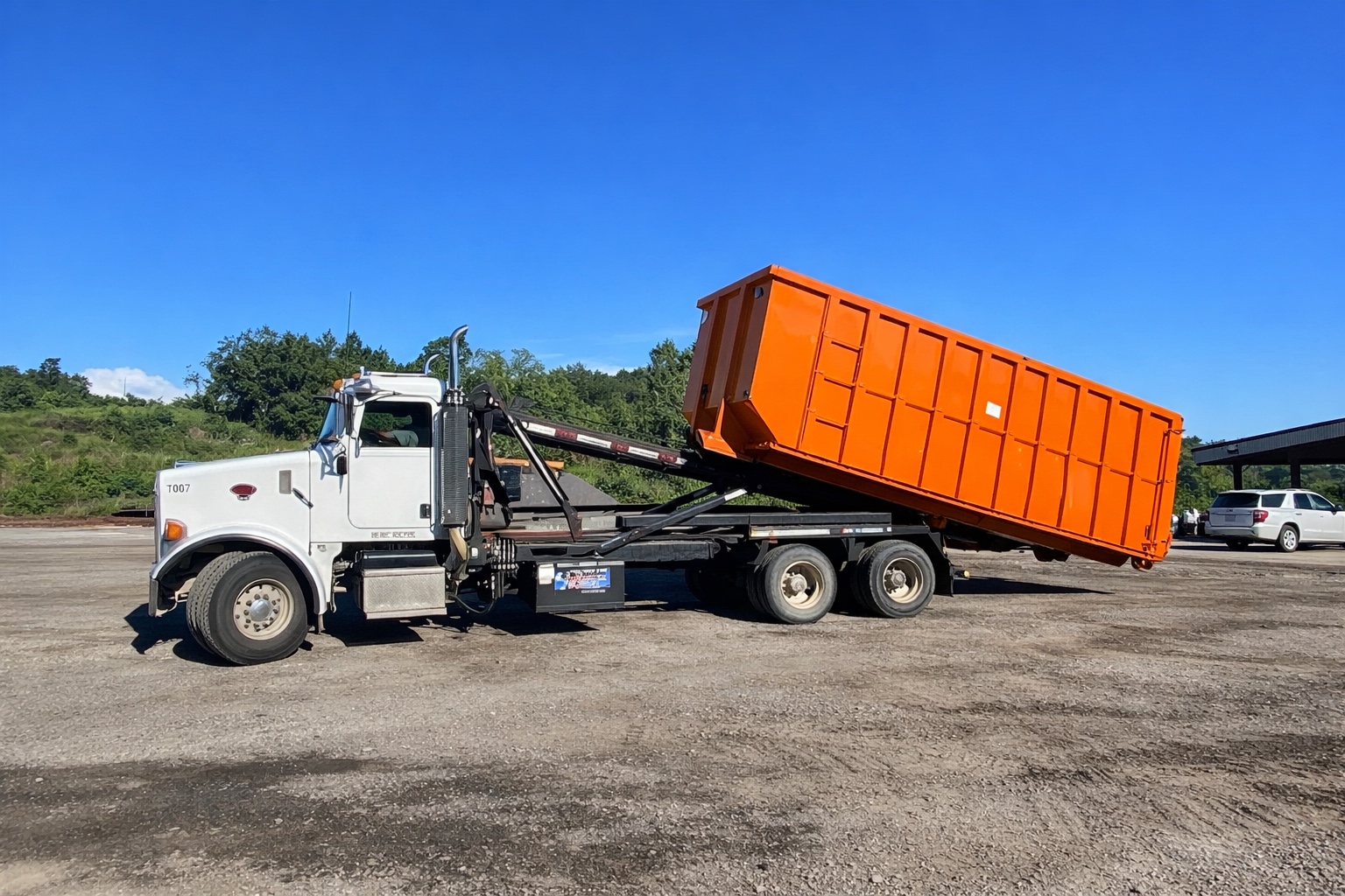 CM DUMPSTERS truck loading a dumpster
